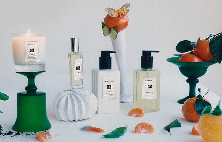 image of Jo Malone London body and hand wash, lotion and cologne in sizes under $50 with 8 globes in the background